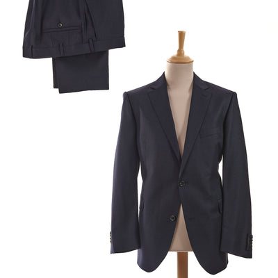 Enhance your formal wardrobe with this sophisticated navy suit from Eduard Dressler. Crafted from the finest fabrics, this tailor-fit suit cuts a sleek silhouette, exuding elegance and refinement. The pure wool construction ensures the utmost comfort and a quality that will stand the test of time.